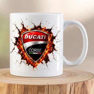 Ducati Breaking Through Ceramic premium ceramic coffee mug featuring the iconic Ducati Corse shield bursting through cracked white ceramic with a glowing molten background.