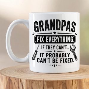 Grandpas Fix Everything ceramic coffee mug with handyman-themed typography and tool illustrations on a white mug.