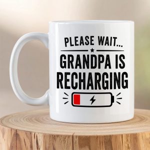 Please Wait Grandpa Is Recharging ceramic coffee mug with battery icon and bold black typography on a white mug.